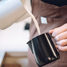 Load image into Gallery viewer, Rhino Coffee Gear 360ml black non-stick milk jug with latte art pouring spout, white jug pouring into smaller black jug
